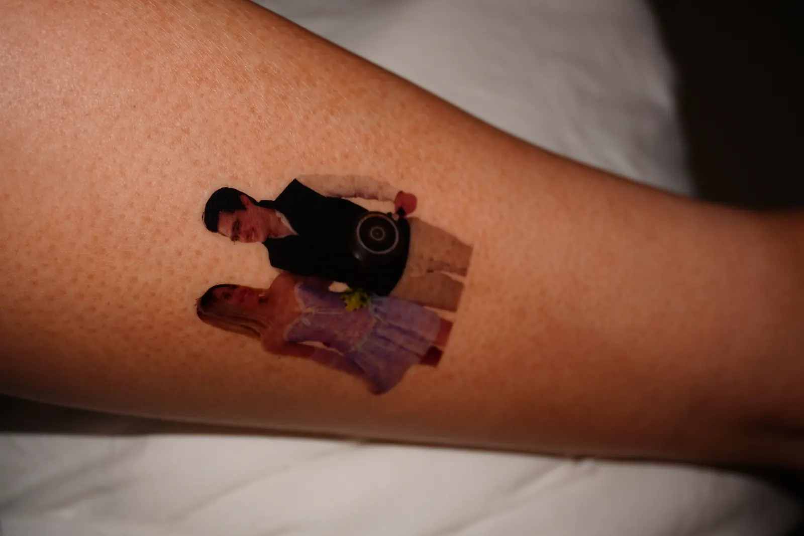Temporary tattoo of a cut-out couple photo, applied on the forearm