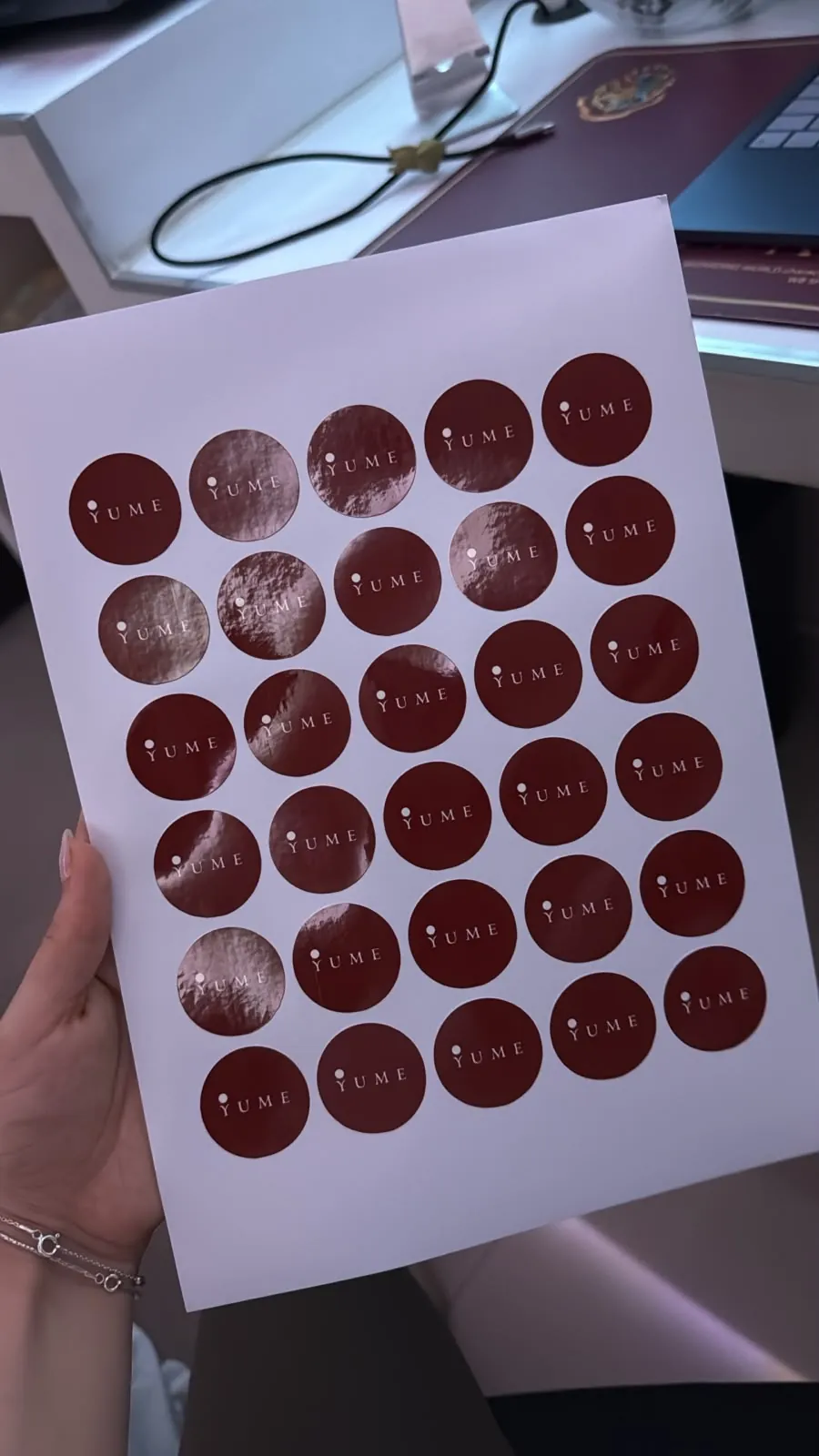 Sheet of circular stickers with the Yume logo in a metallic finish