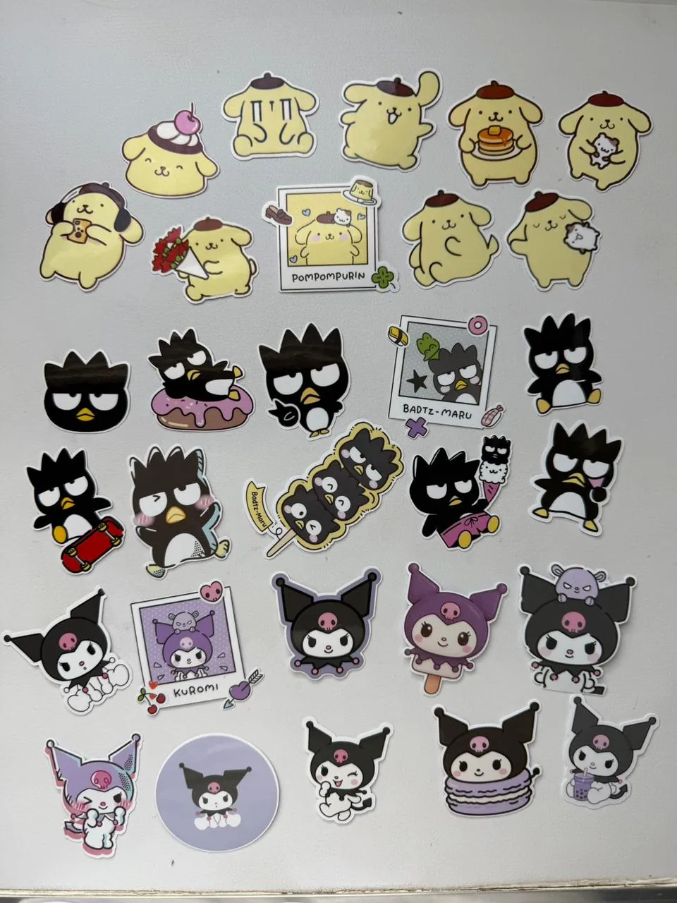 Sanrio's Pompompurin, Badtz-Maru and Kuromi stickers on vinyl