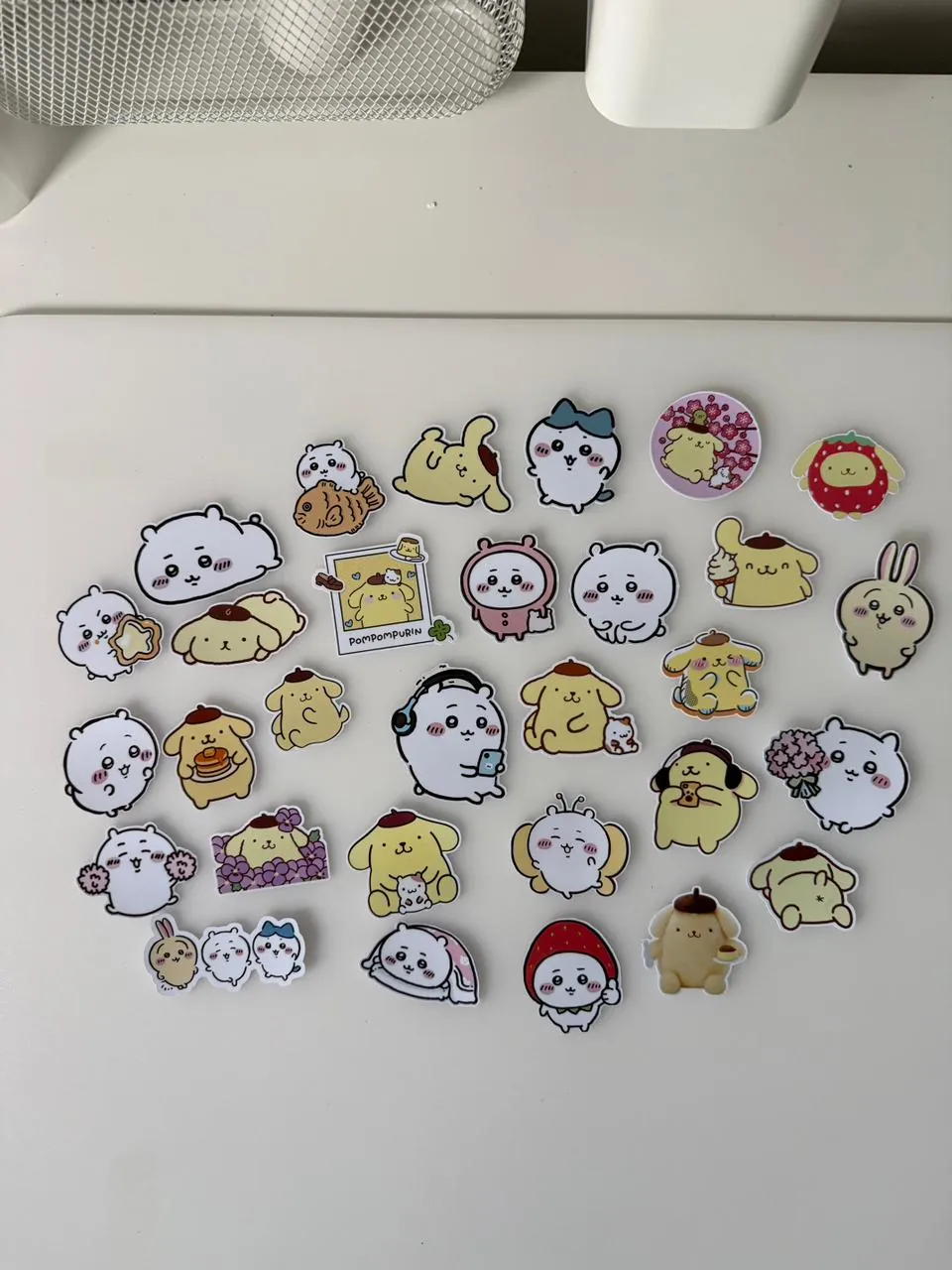Sheets of Pompompurin and Chiikawa character stickers on vinyl